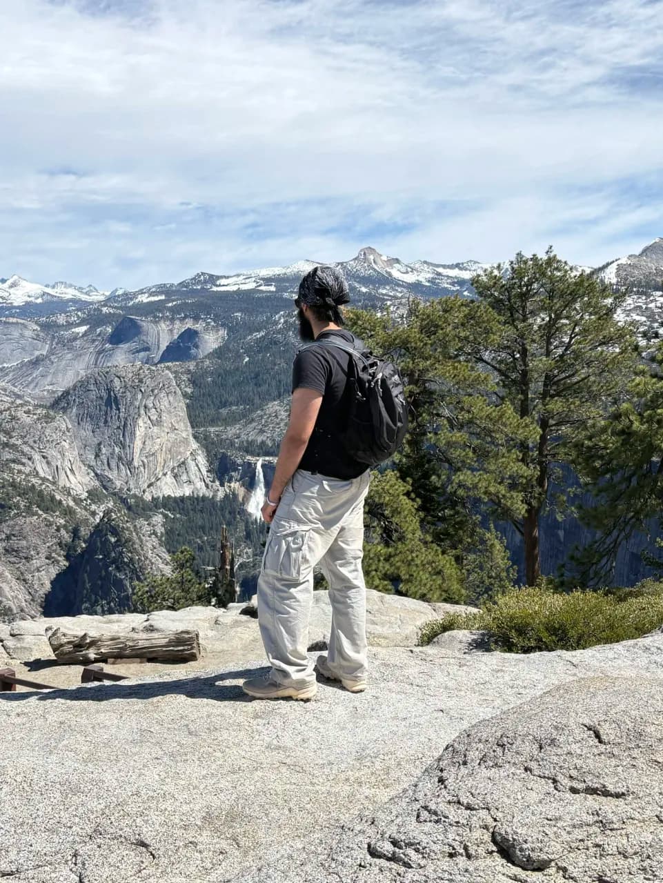 Arjen with a backpack overlooking a mountain valley on a hike.
